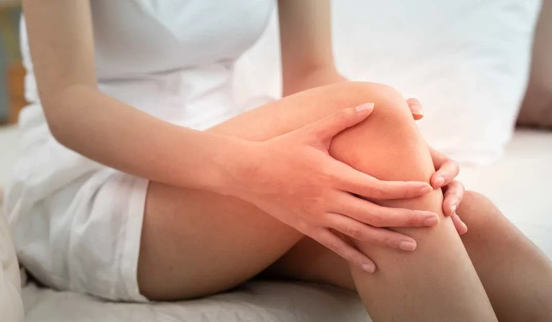 patient holding knee to indicate joint pain and possible instability