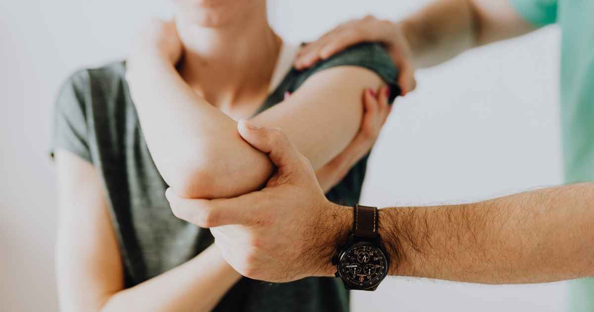 Physician preparing patient for platelet-rich plasma injection for orthopedic joint treatment
