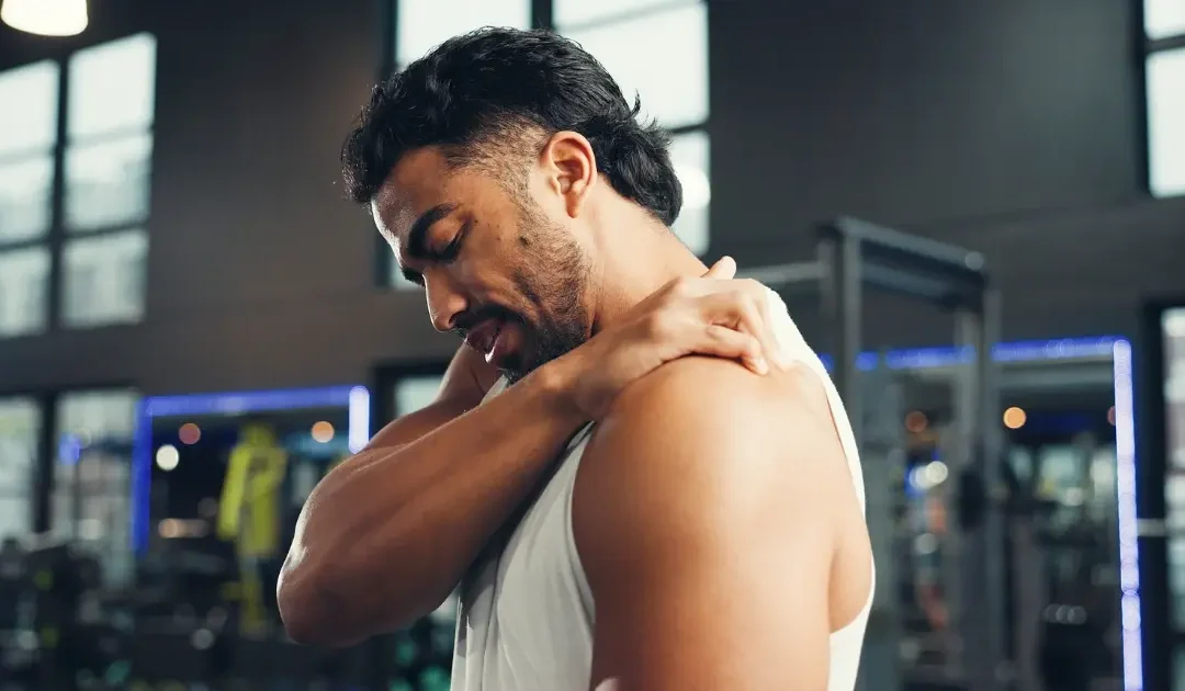 Man holding shoulder showing discomfort from chronic joint condition