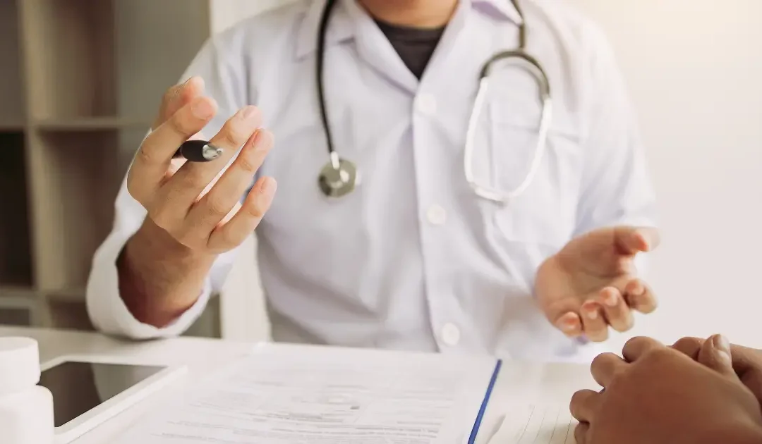 Doctor explaining PRP and A2M treatment options for joint degeneration.